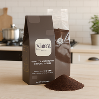 Vitality Mushroom Coffee 12oz bag with opened ground coffee pouch on kitchen counter. Medium roast with Lion’s Mane and Chaga mushrooms.